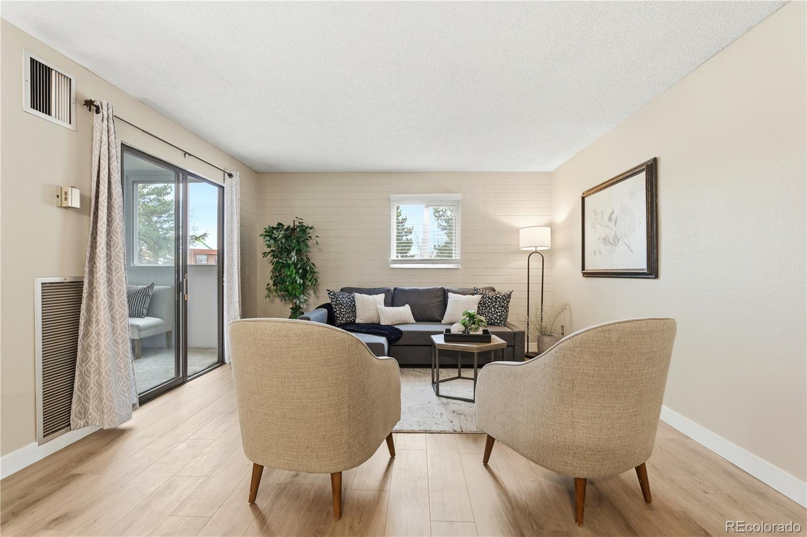 2880 South Locust Street, Unit 200S Denver, CO 80222 - Photo 4 of 43 a living room with furniture and a window