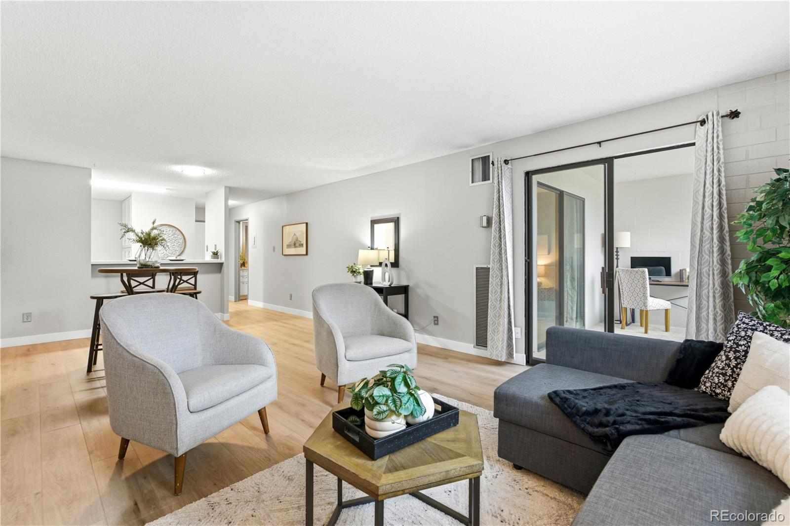2880 South Locust Street, Unit 200S Denver, CO 80222 - Photo 5 of 43 a living room with furniture and a wooden floor