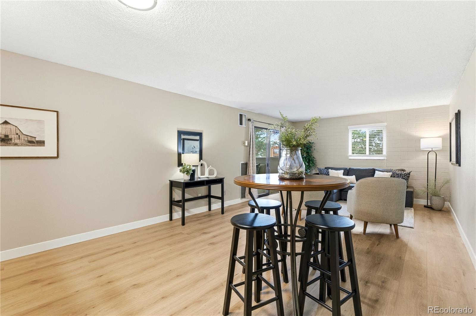 2880 South Locust Street, Unit 200S Denver, CO 80222 - Photo 6 of 43 a view of a dining room with furniture and wooden floor