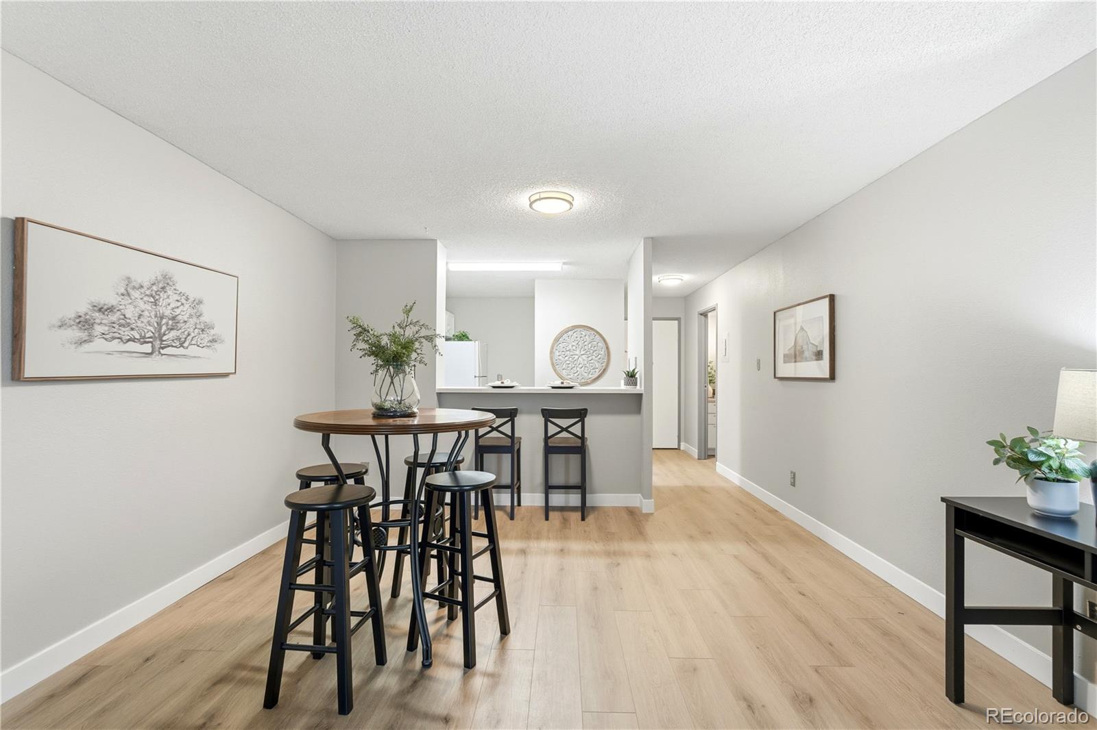 2880 South Locust Street, Unit 200S Denver, CO 80222 - Photo 7 of 43 a view of a dining room with furniture and wooden floor