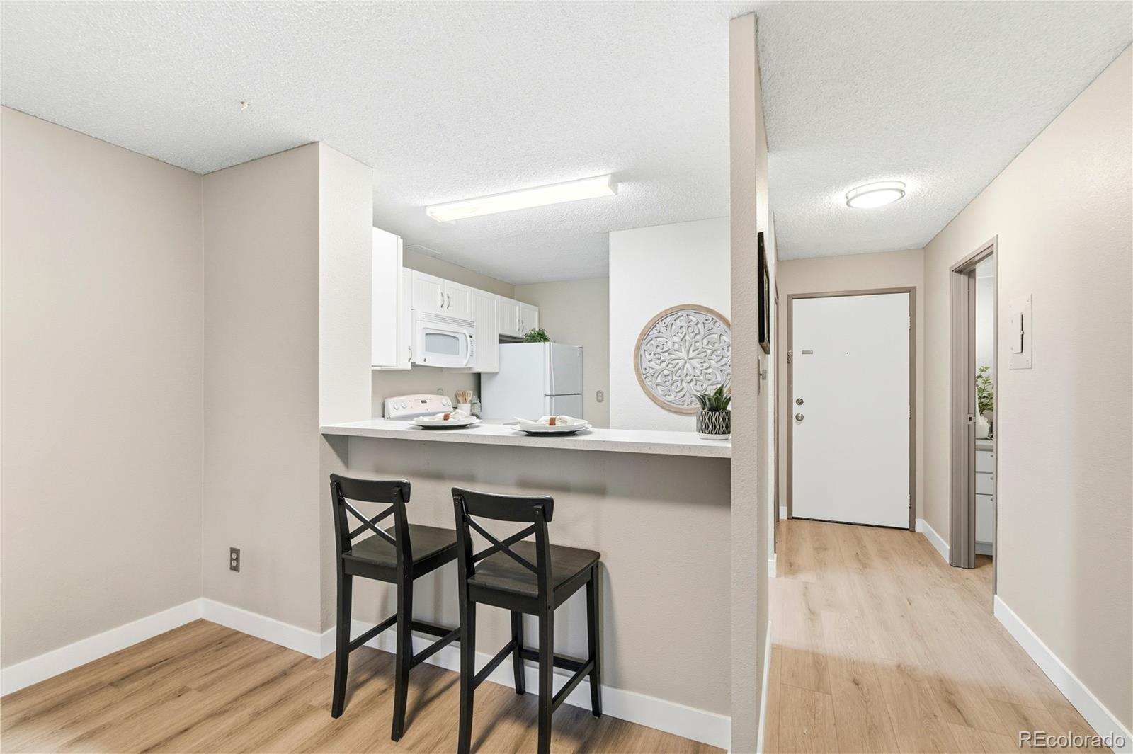 2880 South Locust Street, Unit 200S Denver, CO 80222 - Photo 8 of 43 a kitchen with a table and chairs in it