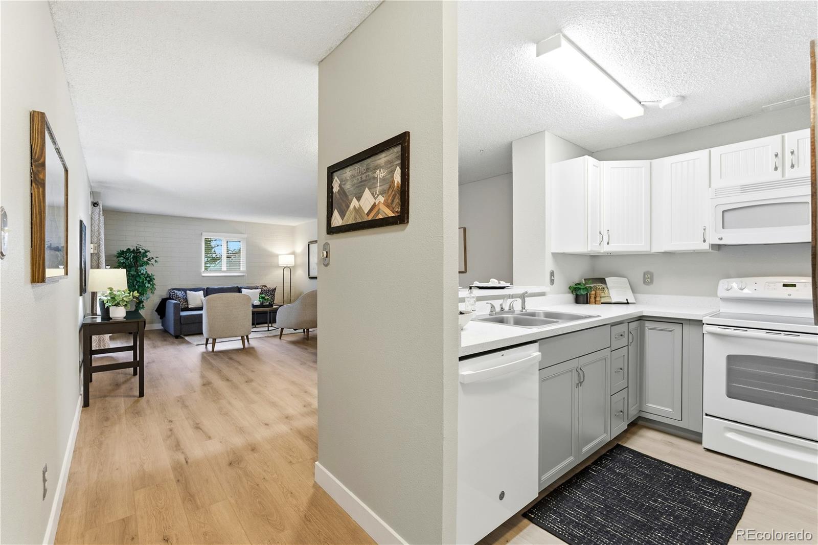 2880 South Locust Street, Unit 200S Denver, CO 80222 - Photo 9 of 43 a kitchen with a sink cabinets and wooden floor