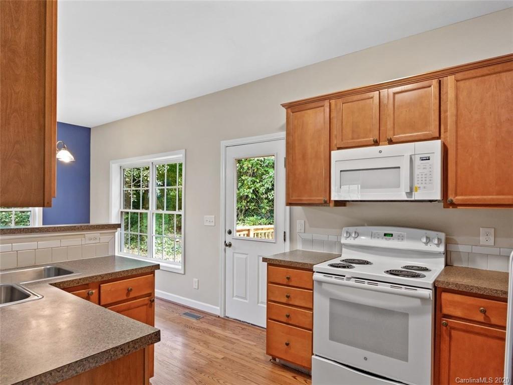 80 Sand Hill Road Asheville, NC 28806 - Photo 12 of 28 a kitchen with stainless steel appliances a stove a sink and a microwave