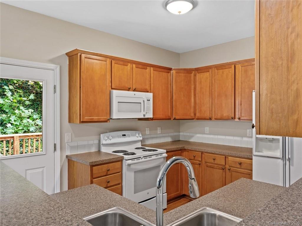 80 Sand Hill Road Asheville, NC 28806 - Photo 13 of 28 a kitchen with stainless steel appliances granite countertop a sink stove and cabinets