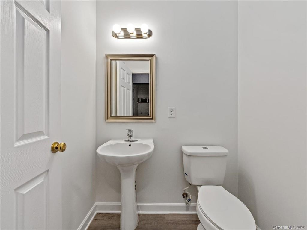 80 Sand Hill Road Asheville, NC 28806 - Photo 14 of 28 a bathroom with a toilet sink and mirror