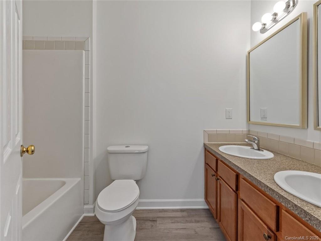 80 Sand Hill Road Asheville, NC 28806 - Photo 18 of 28 a bathroom with a granite countertop toilet a sink and bathtub