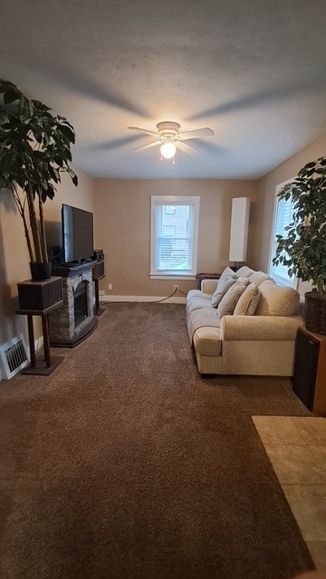 212 West Division Street Bloomington, IL 61701 - Photo 7 of 12 a bedroom with furniture and a flat screen tv