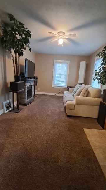 212 West Division Street Bloomington, IL 61701 - Photo 8 of 12 a living room with furniture a chandelier and a window