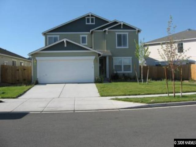 7679 Corso Street Reno, NV 89506 - Photo 1 of 7 a front view of a house with a yard and garage