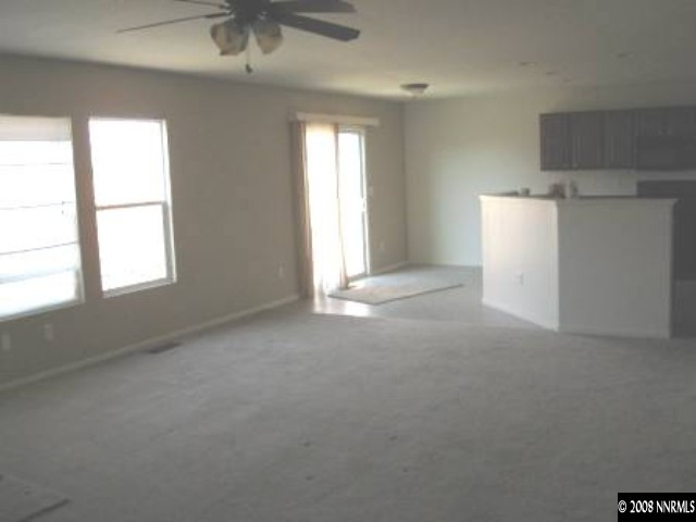 7679 Corso Street Reno, NV 89506 - Photo 4 of 7 an empty room with windows and closet