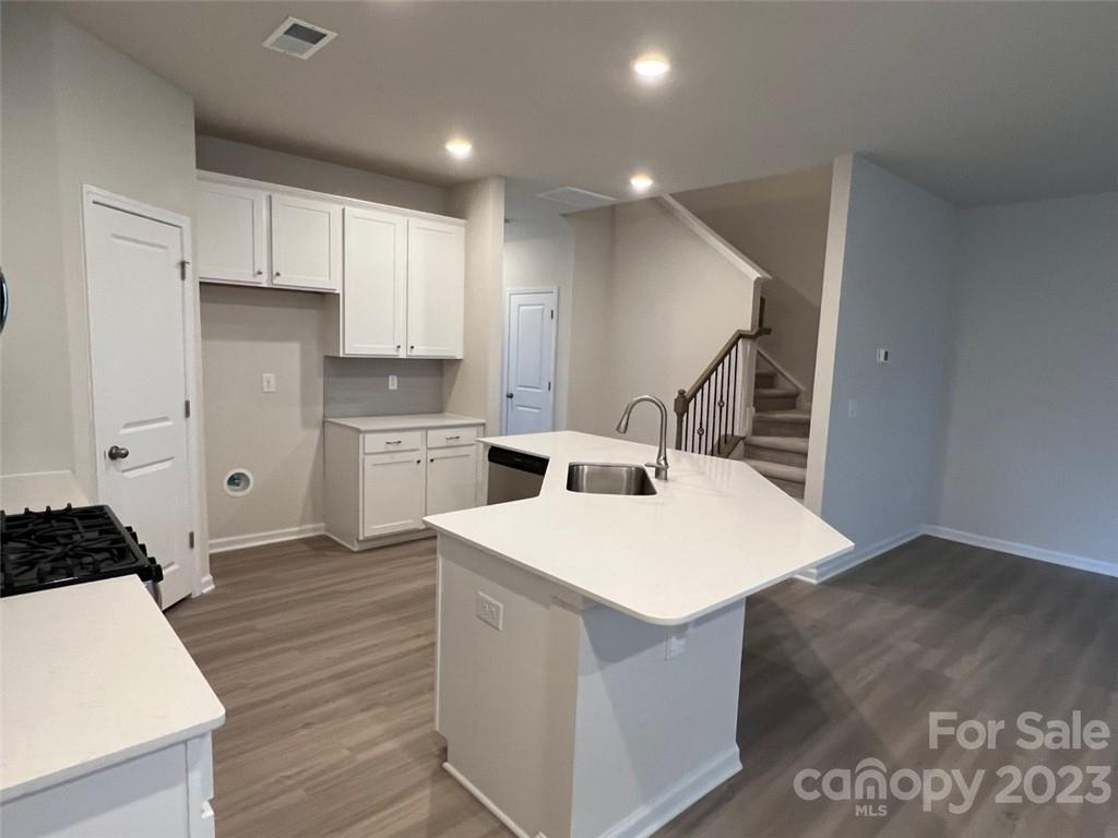 7004 Everly Commons Lane, Unit 2022 Tega Cay, SC 29708 - Photo 10 of 12 a kitchen with a sink a stove and wooden floor