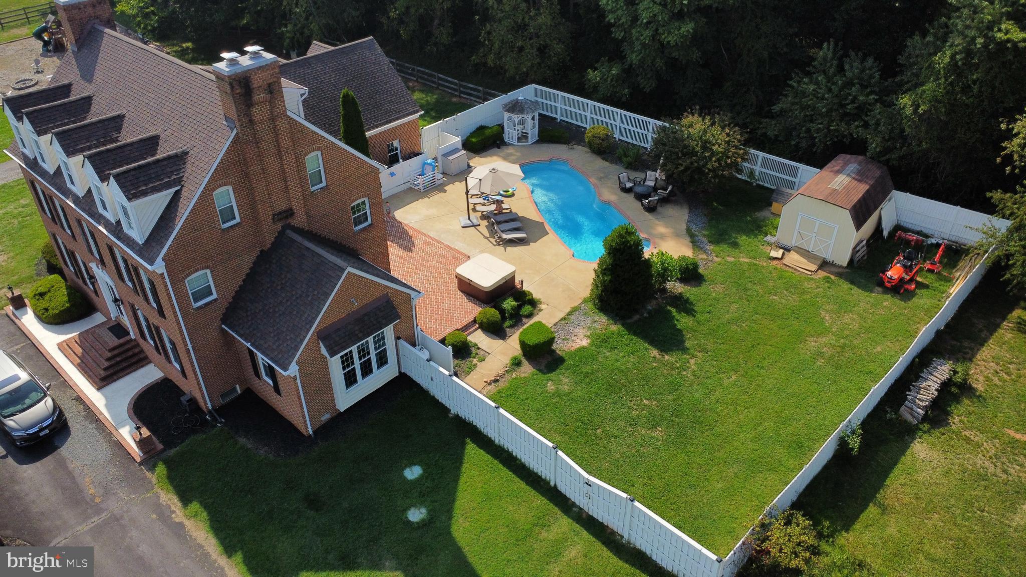 an aerial view of a house with a garden and swimming pool