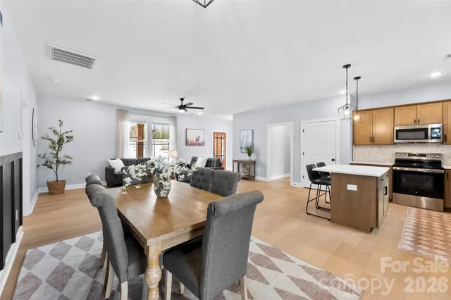 a large kitchen with a table and chairs