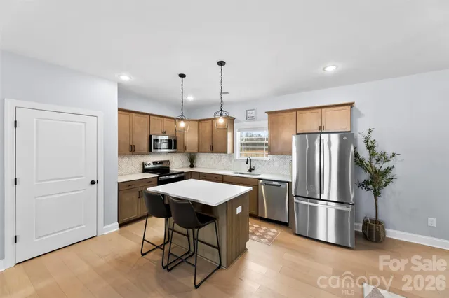 a kitchen with refrigerator and microwave