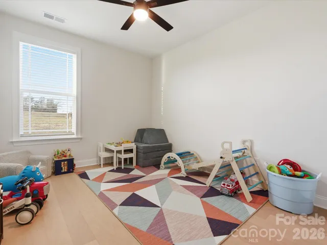a room with furniture a rug and a window