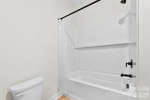 a bathroom with a bathtub and a toilet