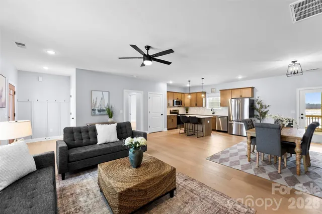 a living room with furniture and view of kitchen