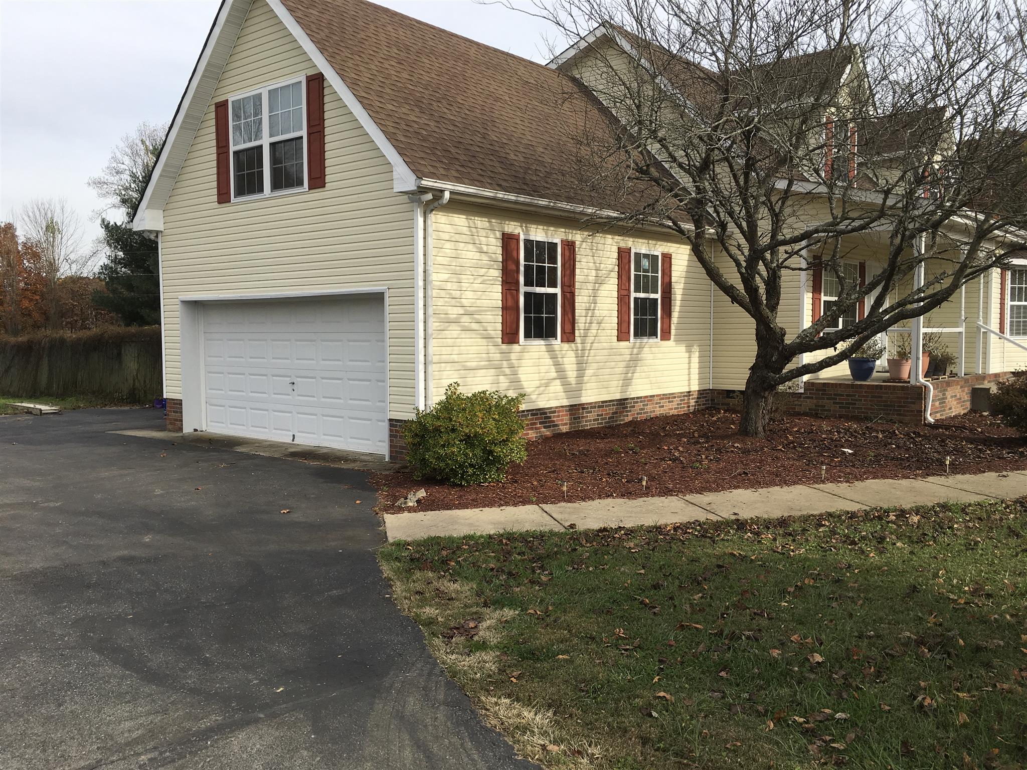 2735 New Hall Road Greenbrier, TN 37073 - Photo 3 of 26 a front view of a house with a yard and garage