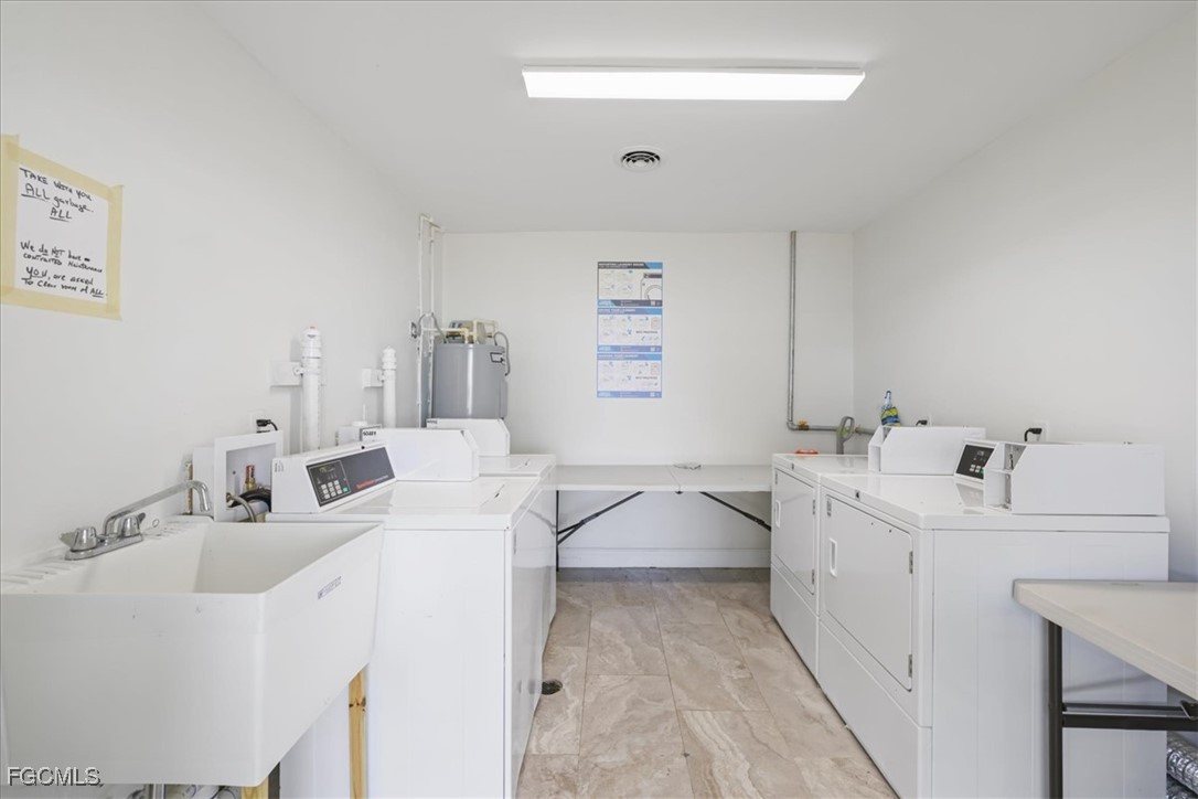 3225 East Riverside Drive, Unit 63F Fort Myers, FL 33905 - Photo 18 of 30 a en suite bathroom with a double vanity sink and mirror