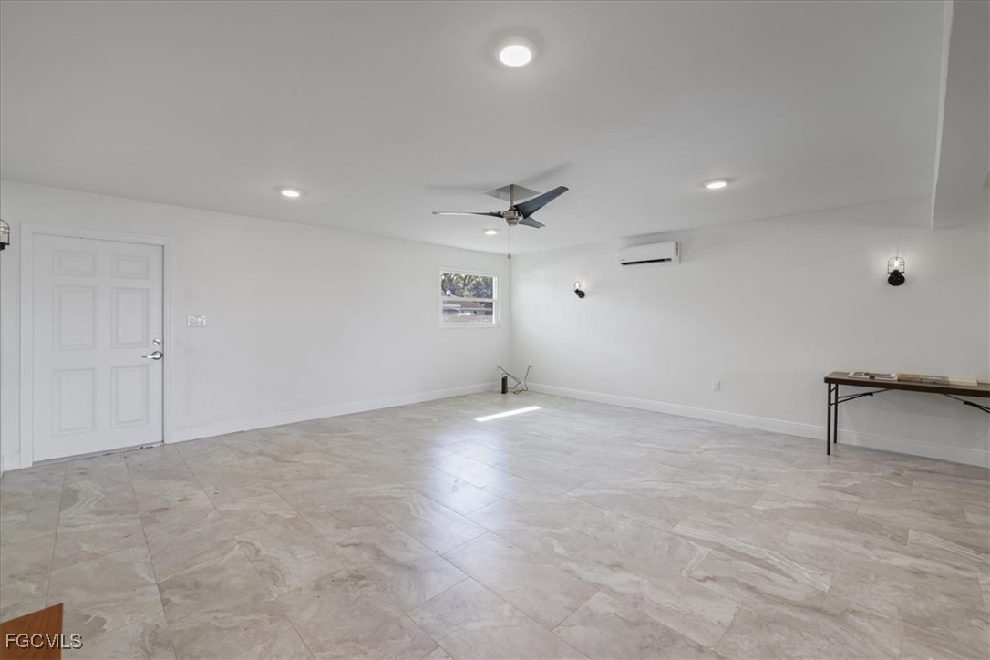 3225 East Riverside Drive, Unit 63F Fort Myers, FL 33905 - Photo 19 of 30 an empty room with a ceiling fan