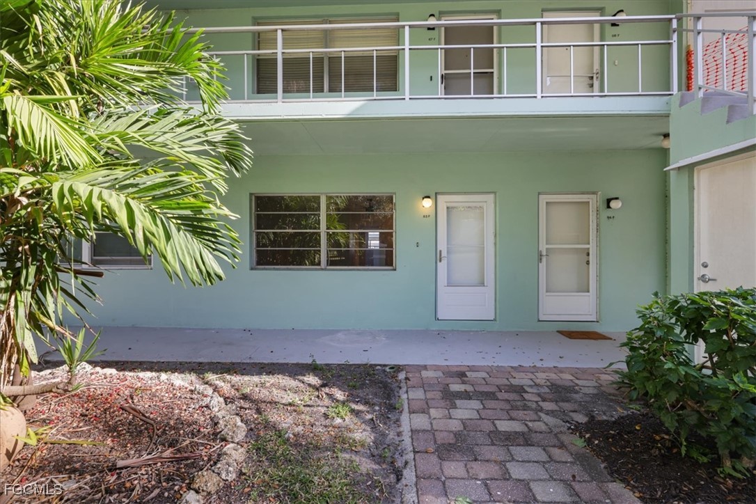 3225 East Riverside Drive, Unit 63F Fort Myers, FL 33905 - Photo 2 of 30 a front view of a house with a yard