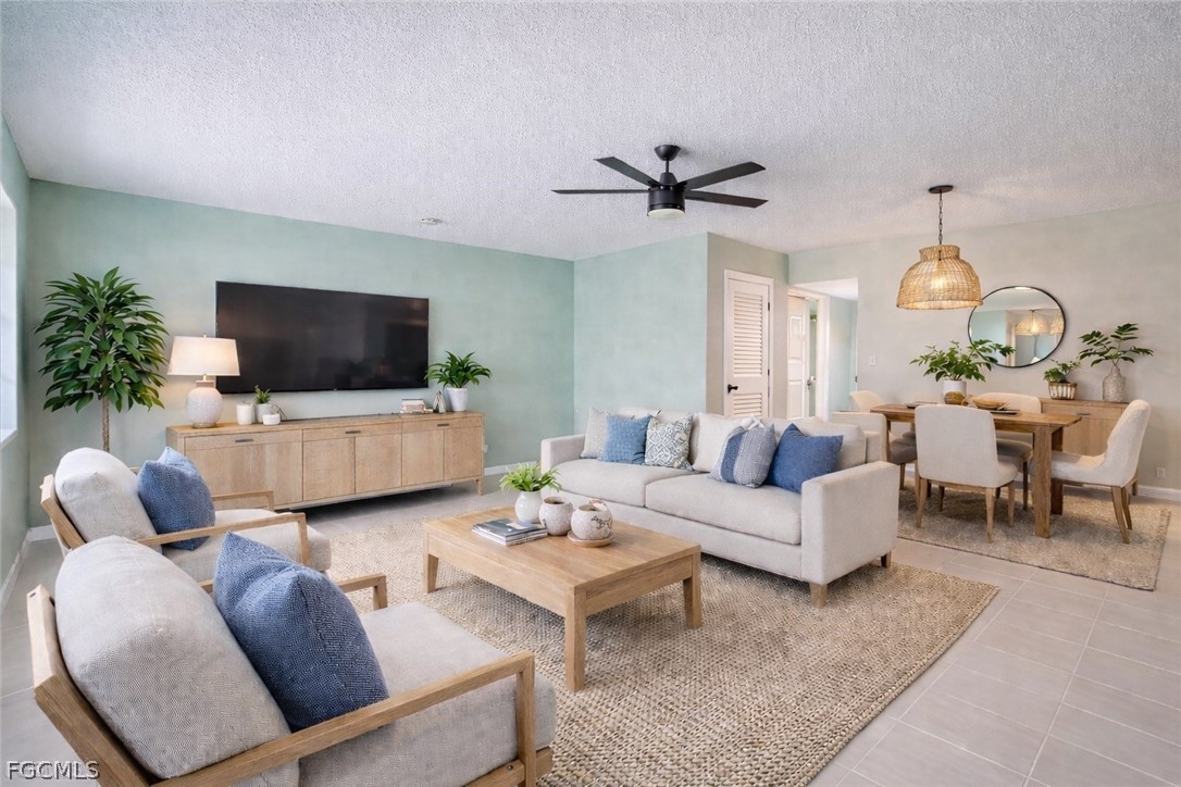 3225 East Riverside Drive, Unit 63F Fort Myers, FL 33905 - Photo 5 of 30 a living room with furniture and a flat screen tv