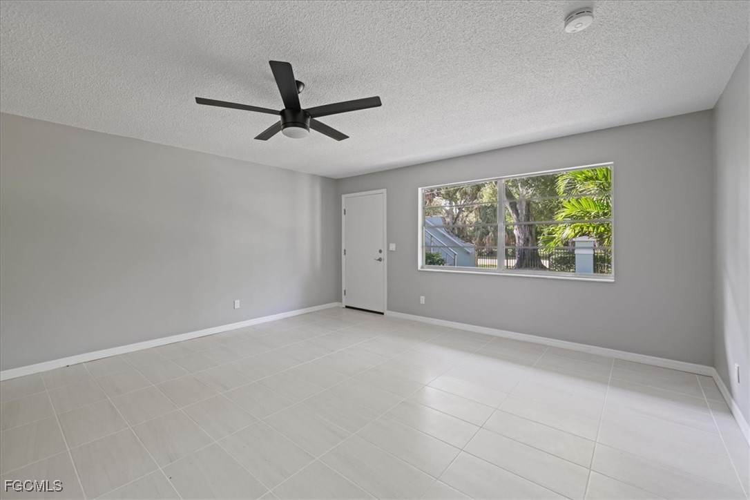 3225 East Riverside Drive, Unit 63F Fort Myers, FL 33905 - Photo 7 of 30 an empty room with windows and ceiling fan view