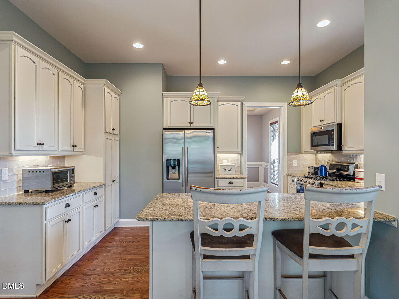 136 Kenneth Lane Willow Spring, NC 27592 - Photo 20 of 94 Kitchen with granite countertops, granite sink, counter level bar, tiffany pendants and 2 pantries