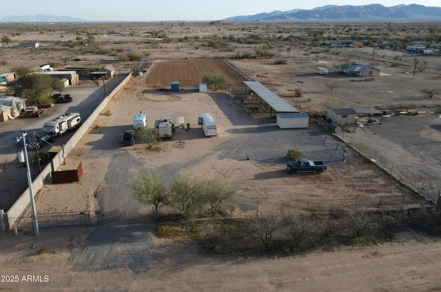 an aerial view of a house with a mountain