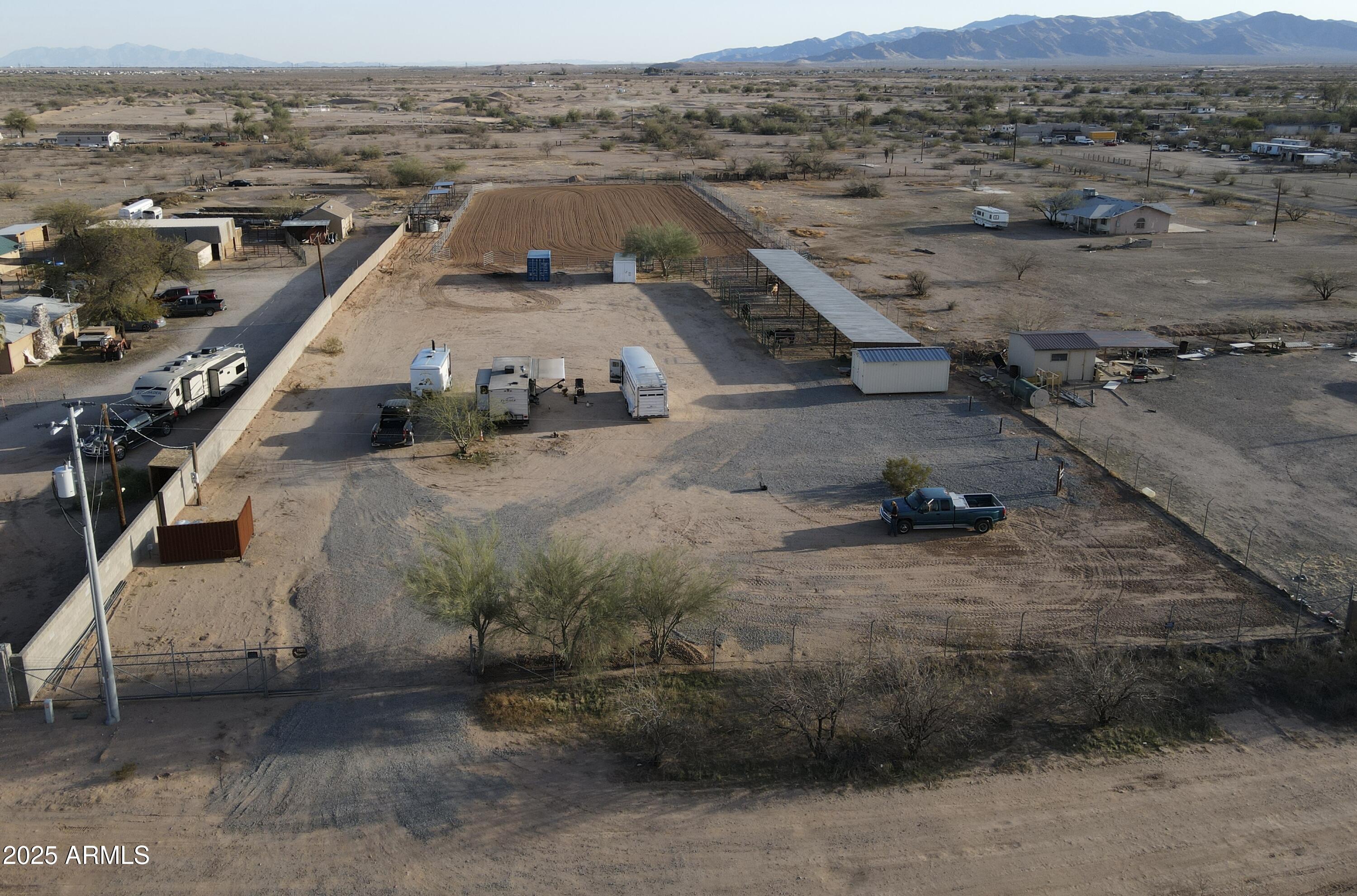 an aerial view of a house with a mountain