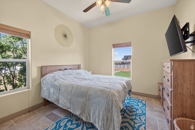 4635 East Sunny Acres Lane Moab, UT 84532 - Photo 56 of 56 Spacious room featuring vaulted ceilings, a ceiling fan with integrated lighting, and two large windows offering ample natural light