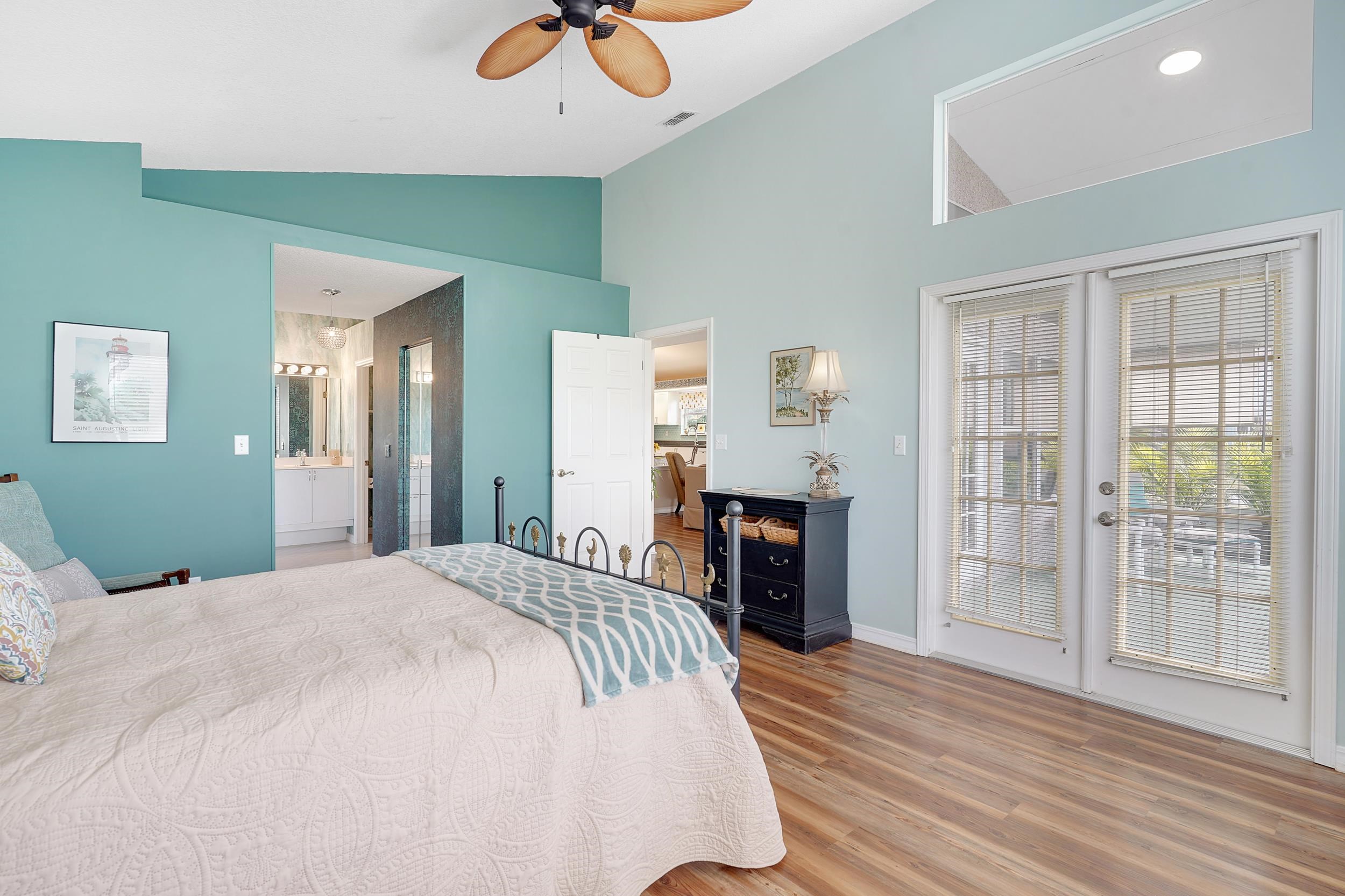 101 Marsh Place North St. Augustine, FL 32080 - Photo 25 of 42 a spacious bedroom with a bed and a chandelier