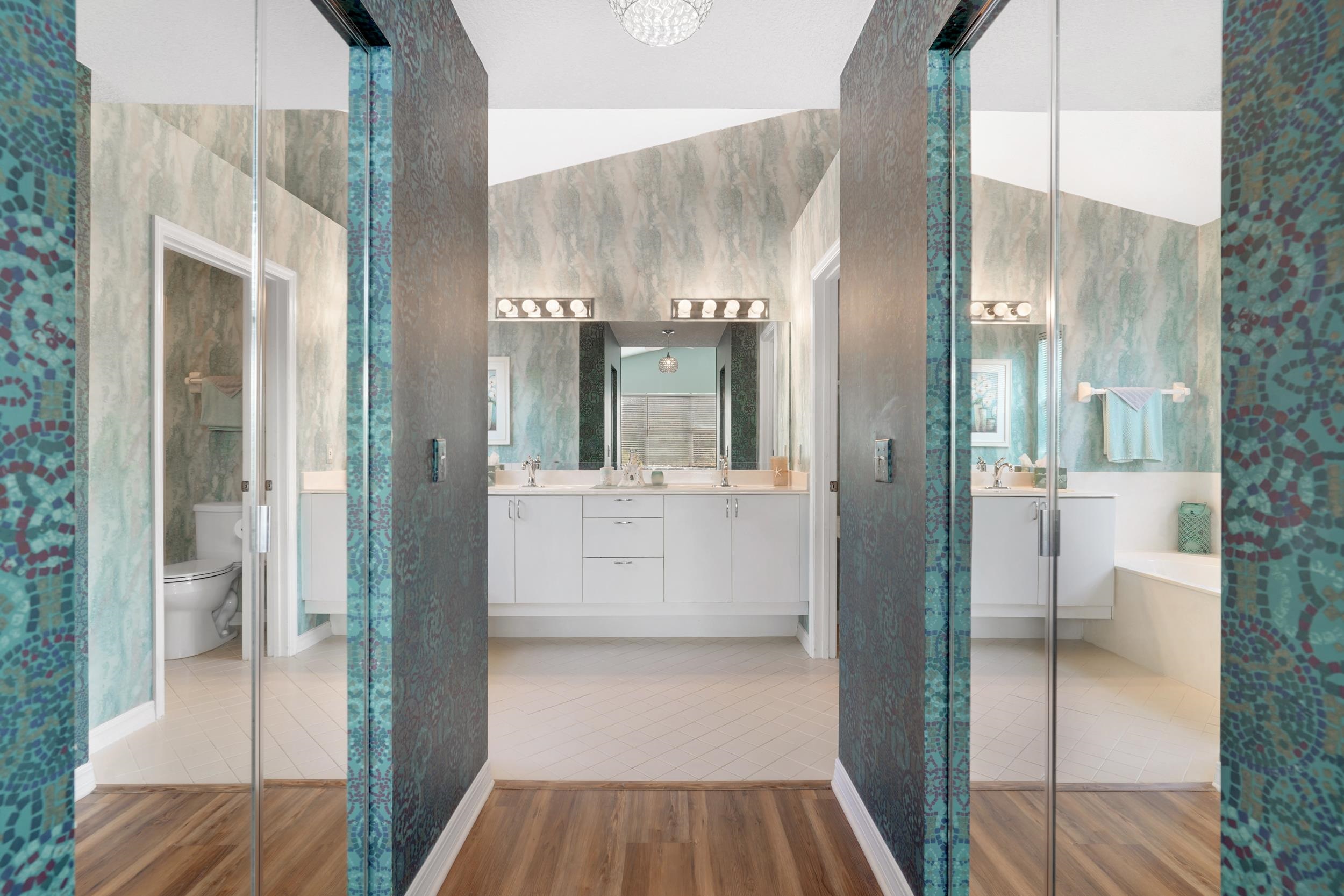 101 Marsh Place North St. Augustine, FL 32080 - Photo 27 of 42 a bathroom with a glass shower door and a mirror