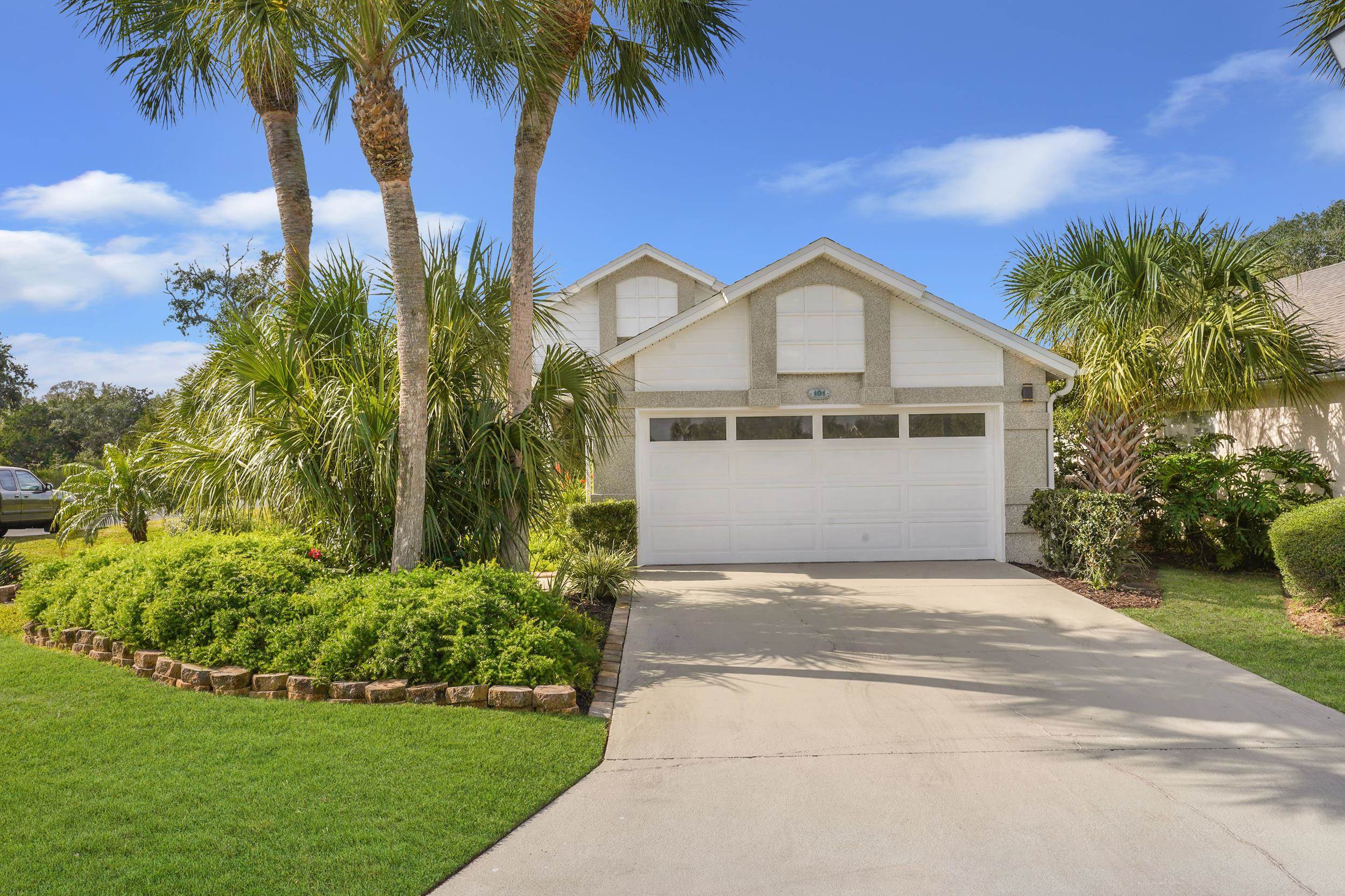 101 Marsh Place North St. Augustine, FL 32080 - Photo 37 of 42 a front view of a house with a garden and yard