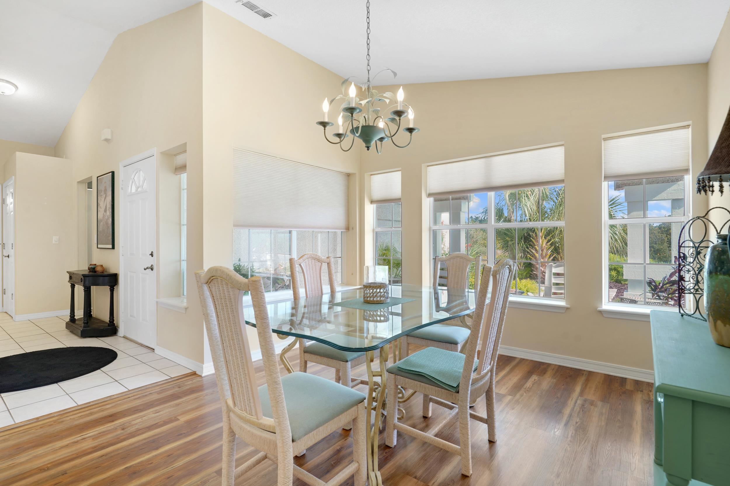101 Marsh Place North St. Augustine, FL 32080 - Photo 9 of 42 a view of a dining room with furniture wooden floor and chandelier