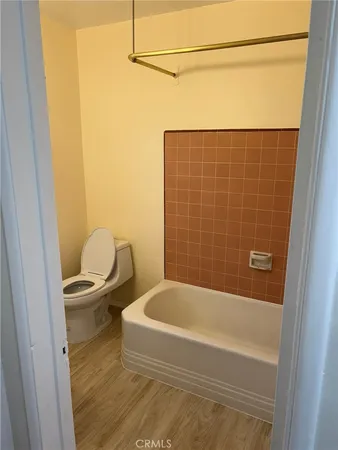 a bathroom with a granite countertop bathtub sink and toilet