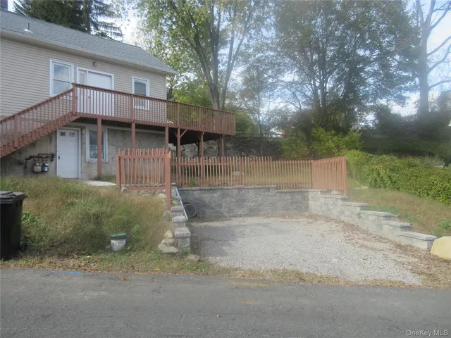 a backyard of a house with table and chairs