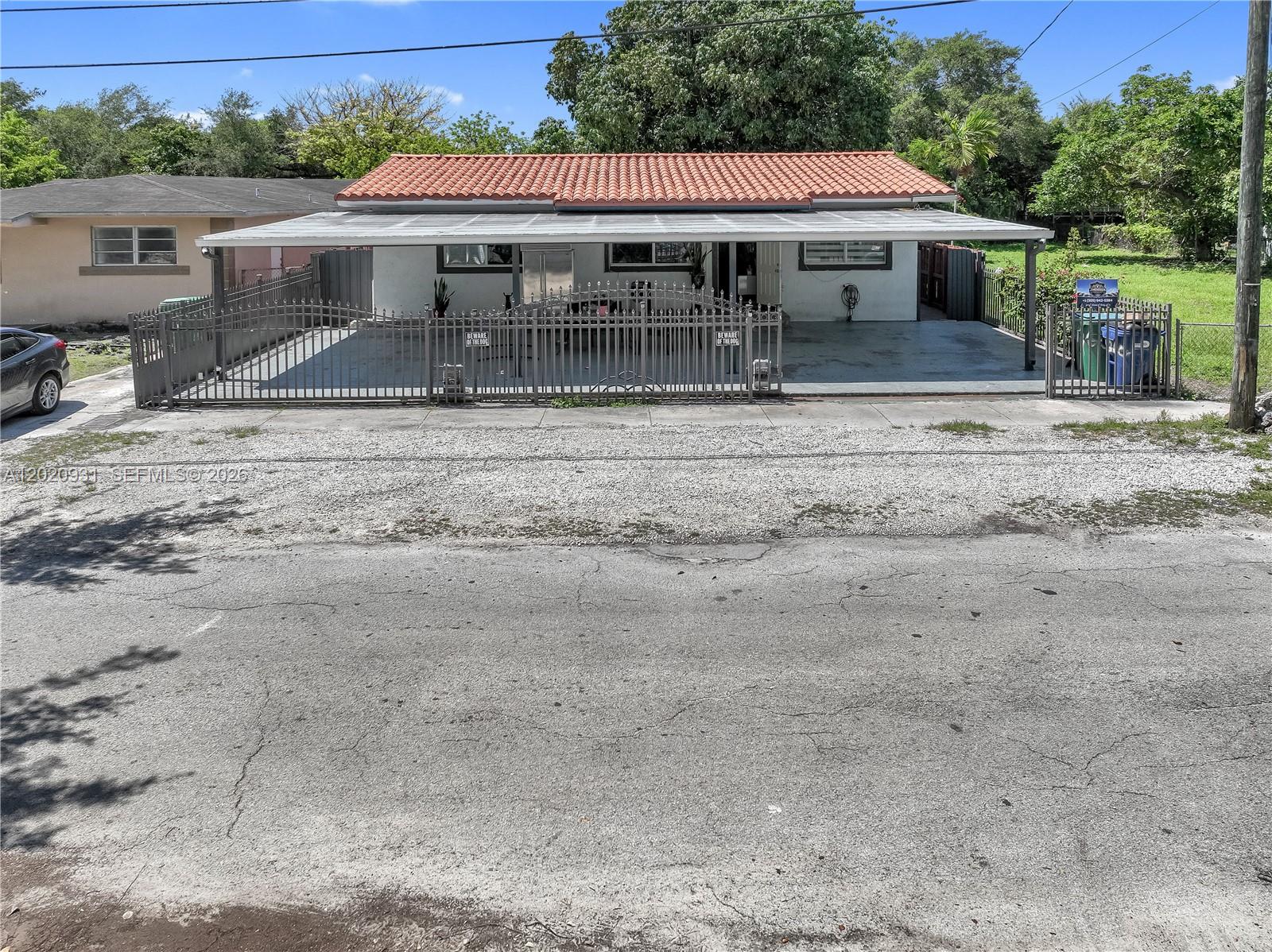 1360 Northwest 77th Street Miami, FL 33147 - Photo 2 of 41 a front view of a house with a yard