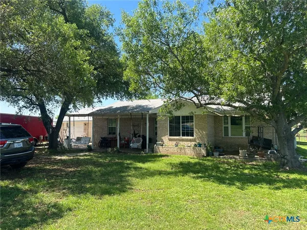 a view of a house with a yard porch and sitting area