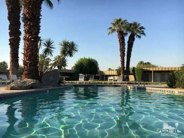 a view of a swimming pool with a table and chairs