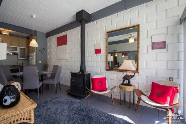 a living room with furniture a rug and white walls