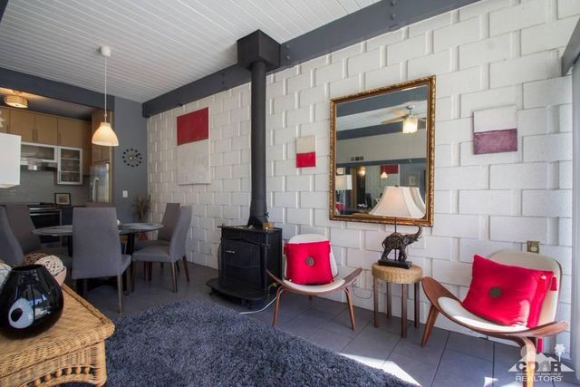 a living room with furniture a rug and white walls