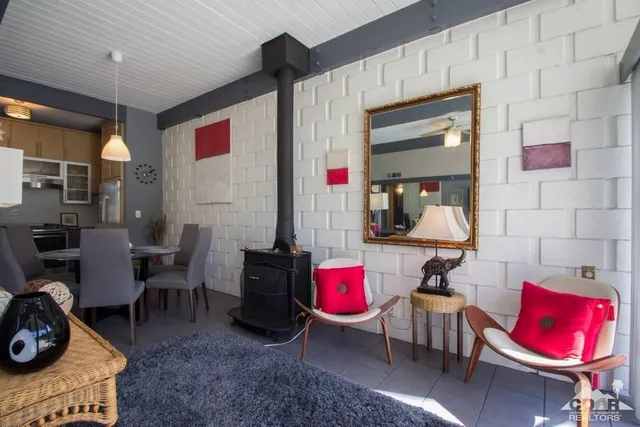 a living room with furniture a rug and white walls