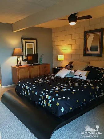 a bedroom with a bed window and couch