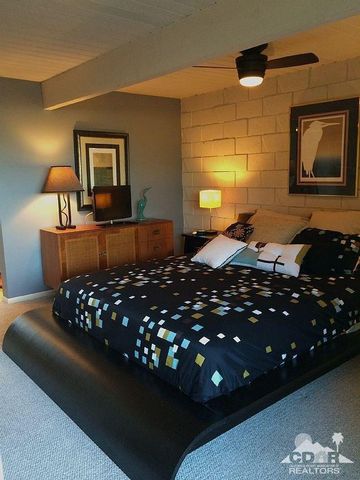 a bedroom with a bed window and couch