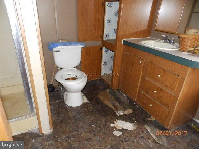 26595 Siloam Road Salisbury, MD 21801 - Photo 5 of 8 a bathroom with a toilet sink and mirror