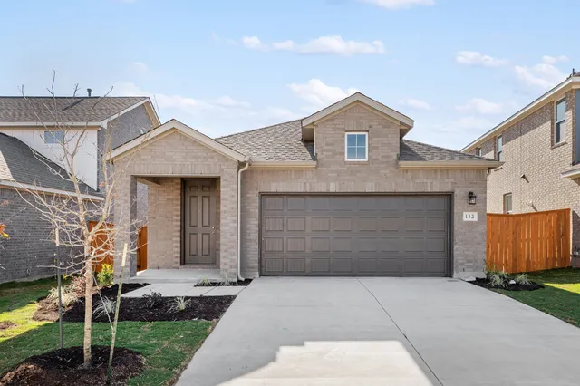 a front view of a house with garage