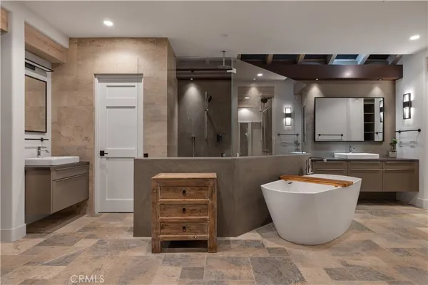 a large room with a sink a large mirror and a vanity