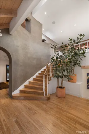 a spacious bedroom with a large bed and a large window