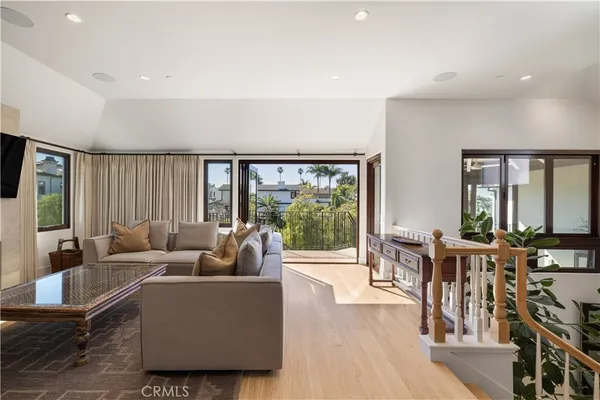 a living room with furniture and large windows